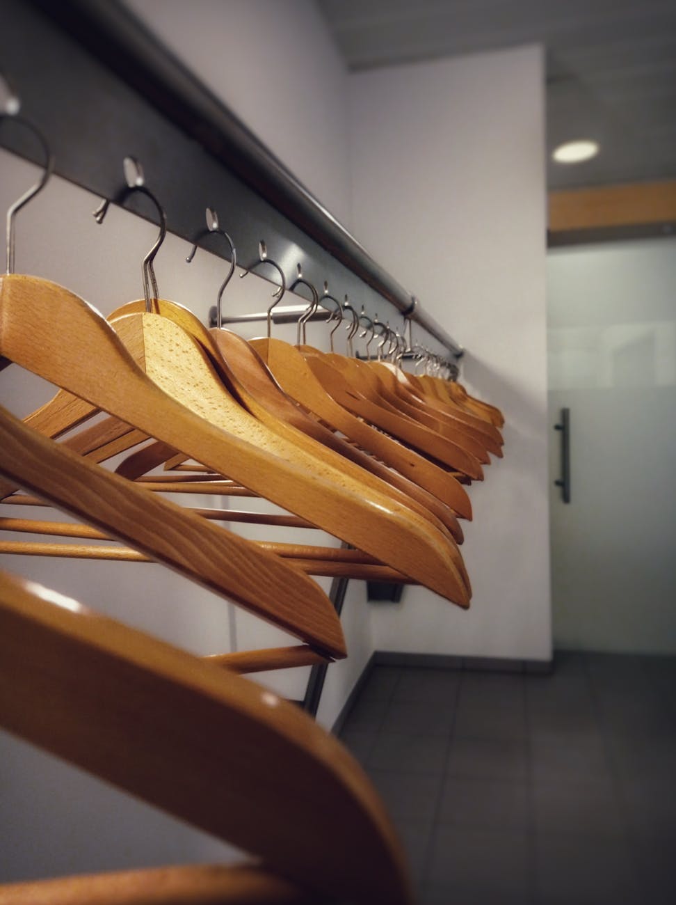 row of wooden hangers in modern cloakroom